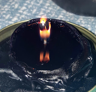 melted votive candle black wax