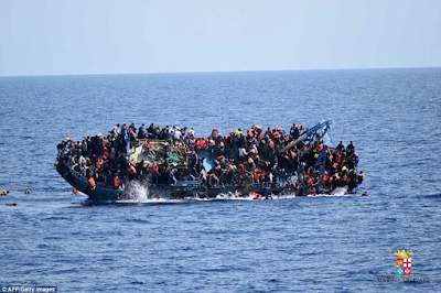 Heart-wrenching photos of migrants being flipped into the sea as their overcrowded boat overturns off the coast of Libya