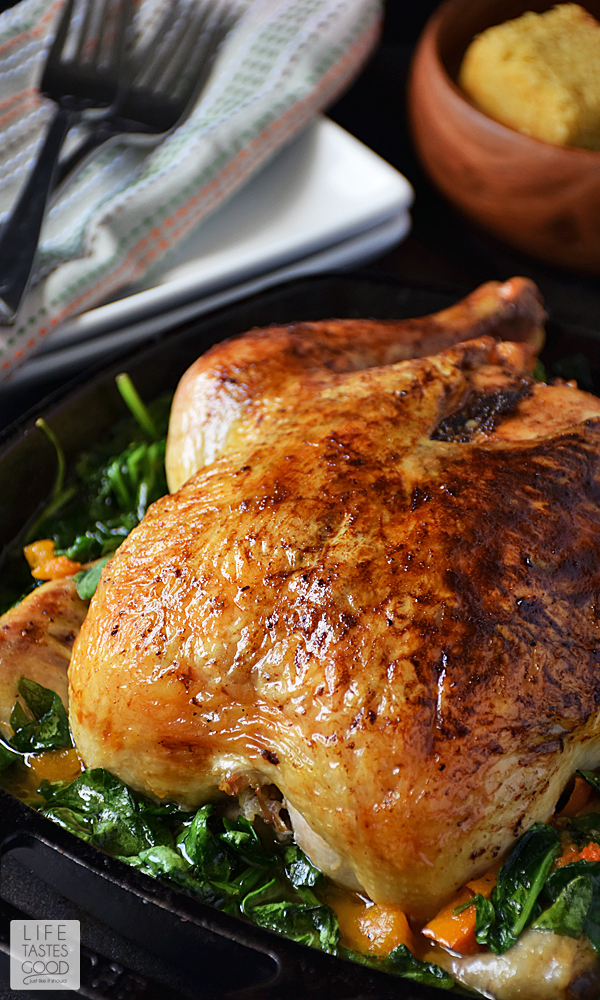 Whole Roasted Chicken with Vegetables | by Life Tastes Good is a comforting meal perfect for the fall season. In addition to the roasted chicken, this complete dinner also incorporates my favorite fall flavor, butternut squash, and Popeye's favorite veg, nutrient rich spinach all cooked together in one skillet. #LTGRecipes #SundaySupper