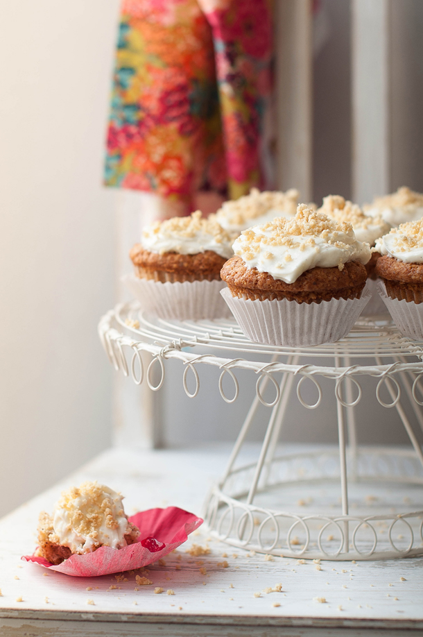 Strawberry & almond muffins with cream cheese frosting and amaretto biscuit crumbs