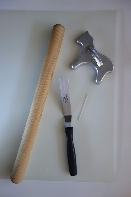 rolling pin, offset spatula, toothpick, cutting board