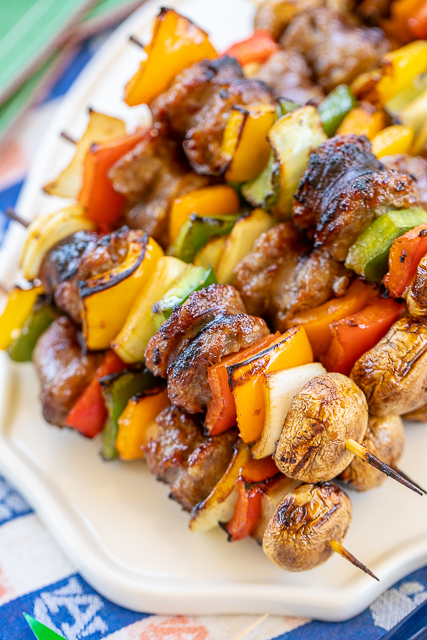 Grilled Bourbon & Coke Brats Skewers - SO good! Perfect party food!! Brats, onions, bell peppers and mushrooms marinated in bourbon, coke, soy sauce, brown sugar, seasoned salt and a little cayenne. Can assemble ahead of time and throw on the grill when you are ready to eat. These were a HUGE hit at our last tailgate. NO leftovers! A must for your next tailgate #tailgating #brats #grilling #partyfood Grilled Bourbon & Coke Brats Skewers - SO good! Perfect party food!! Brats, onions, bell peppers and mushrooms marinated in bourbon, coke, soy sauce, brown sugar, seasoned salt and a little cayenne. Can assemble ahead of time and throw on the grill when you are ready to eat. These were a HUGE hit at our last tailgate. NO leftovers! A must for your next tailgate #tailgating #brats #grilling #partyfood