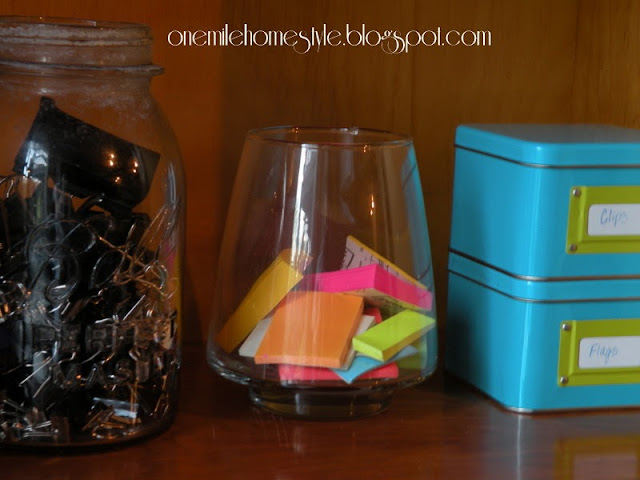 Clear jars to organize post-its and binder clips