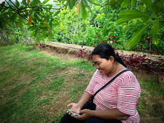 Woman Traveler Smilling With Her Smartphone In The Peaceful Garden North Bali Indonesia