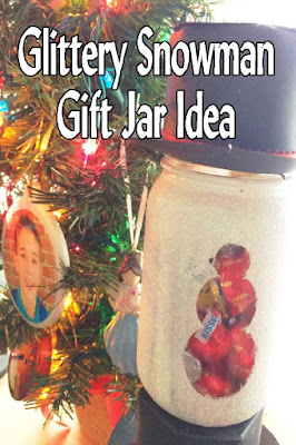 Make a snowman that will last all year long and is super cute with a bit of sparkle, a cute magic hat, and some yummy chocolate candies.  This snowman gift jar is the perfect Teacher gift, neighbor gift, or gift for your best friend.  It's easy and worth every little bit of glitter. #snowman #christmasgift #candyjar #diypartymomblog