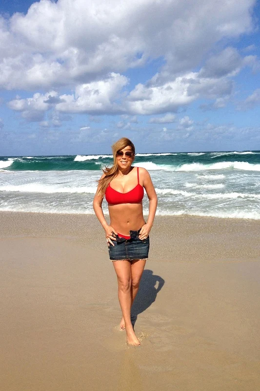 Mariah Carey flaunts curves in a red bikini top and denim mini skirt in Australia