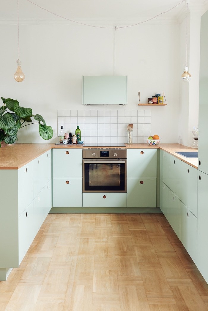 scandinavian apartment with a mint kitchen and lots of art