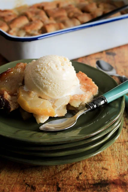 Pear Dumpling Cobbler, a simple and delicious recipe of juicy pears cooked to perfection in a sweet buttery sauce between two layers of dumpling dough.   A gorgeous presentation for an elegant dinner.