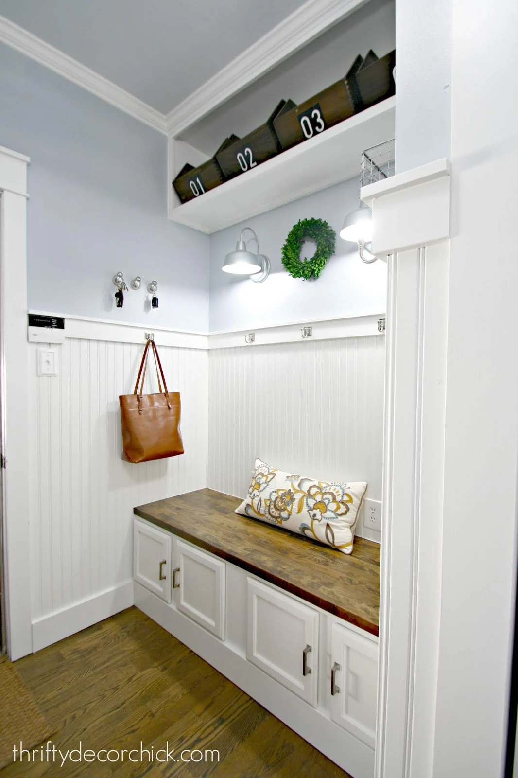 White mud room with beadboard and bench