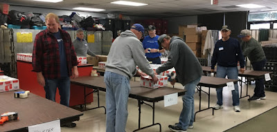 Taping the boxes. Over 430 boxes were packed and taped