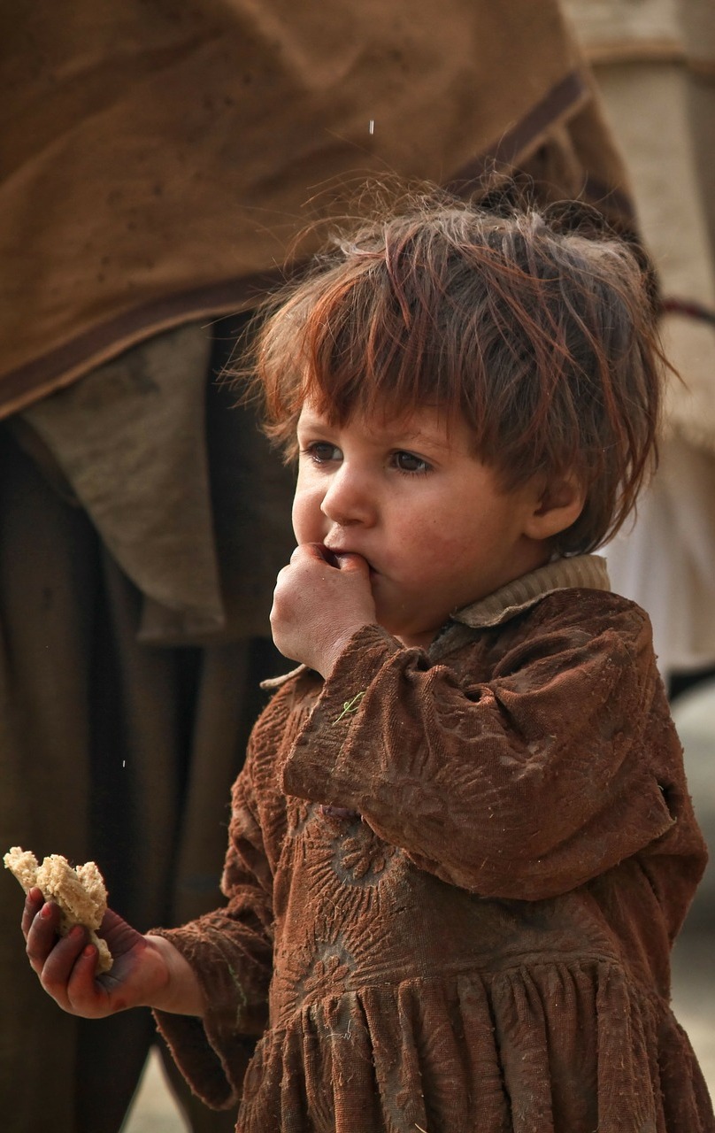 A child with piece of bread. A child with piece of bread.