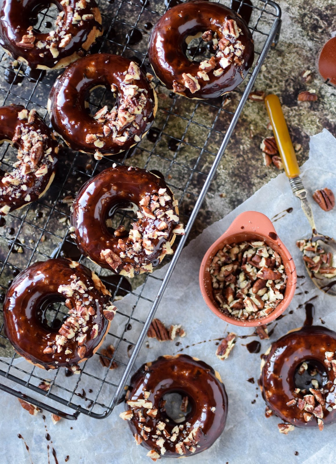 These moist and delicious chocolate chip studded, banana bread doughnuts are dipped in a rich chocolate ganache before being sprinkled with chopped pecans for added crunch. You'll be back for seconds, or even thirds.
