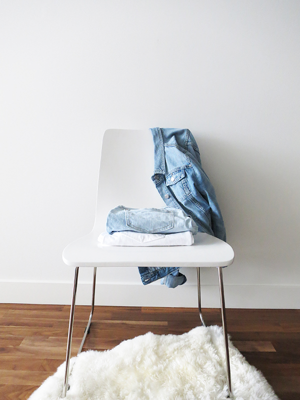 Vancouver-based beauty, life and style blogger Lisa Wong of Solo Lisa talks essential summer denim for the aspiring minimalist. Her picks—a Banana Republic distressed denim jacket in light blue, Old Navy boyfriend shorts in distressed light blue, and AG 'The Prima' white cigarette jeans—are styled on a white chair against a white wall.
