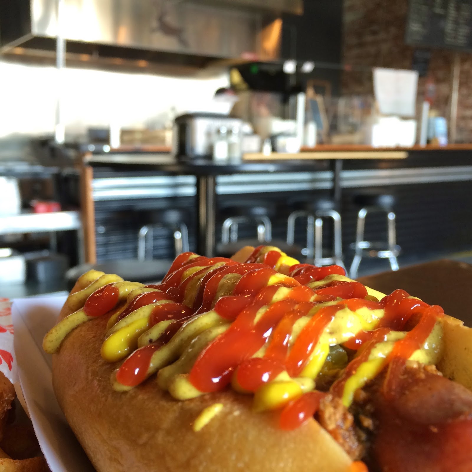 Beef Frank topped with Dill Pickle Relish, Chili, and the most beautiful array of Ketchup and Mustard you've ever seen