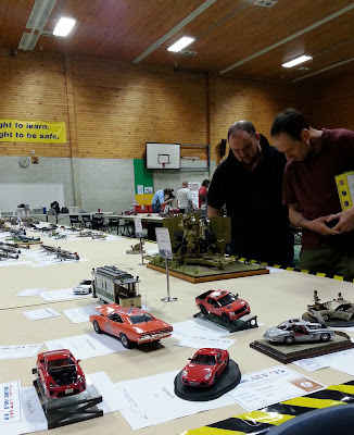 Two men looking at a display of scale model cars.