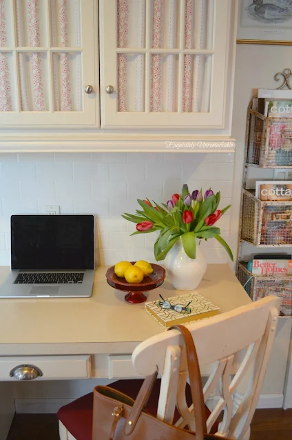 Kitchen desk with fabric on glass cabinets