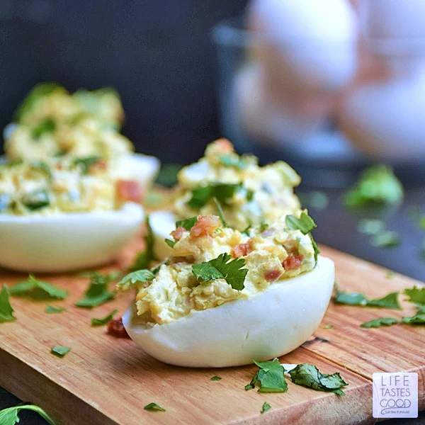 Jalapeno Popper Deviled Eggs | by Life Tastes Good. Can you imagine the goodness?! A deliciously tasty twist on Jalapeno Poppers loaded with cream cheese, fresh jalapeno, cheddar cheese, and BACON all stuffed into an edible dish you can eat with your hands! This might just be the perfect appetizer...