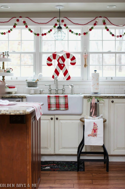 Whimsical and cheery Christmas decor in kitchen with farmhouse sink