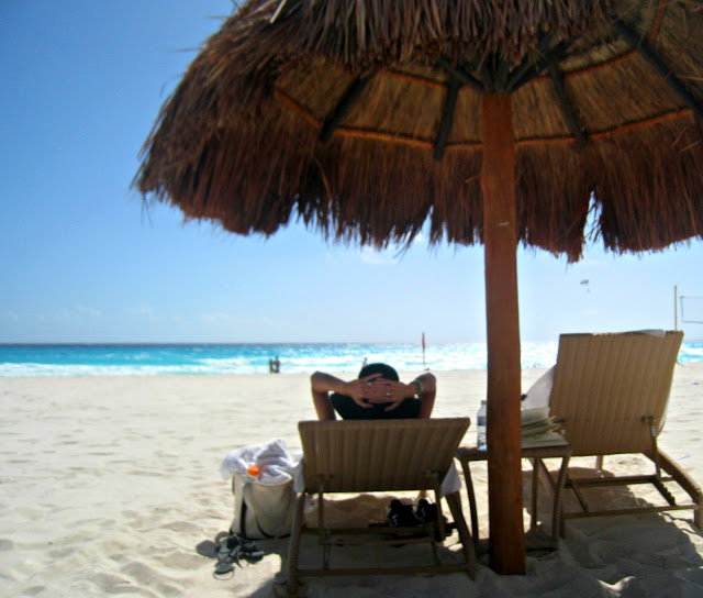 A couple of lawn chairs sitting on top of a beach