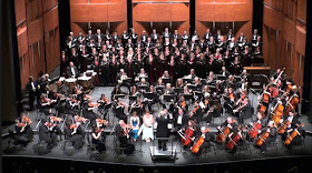 An orchestra with soloists and choir, performing Beethoven's Ninth Symphony