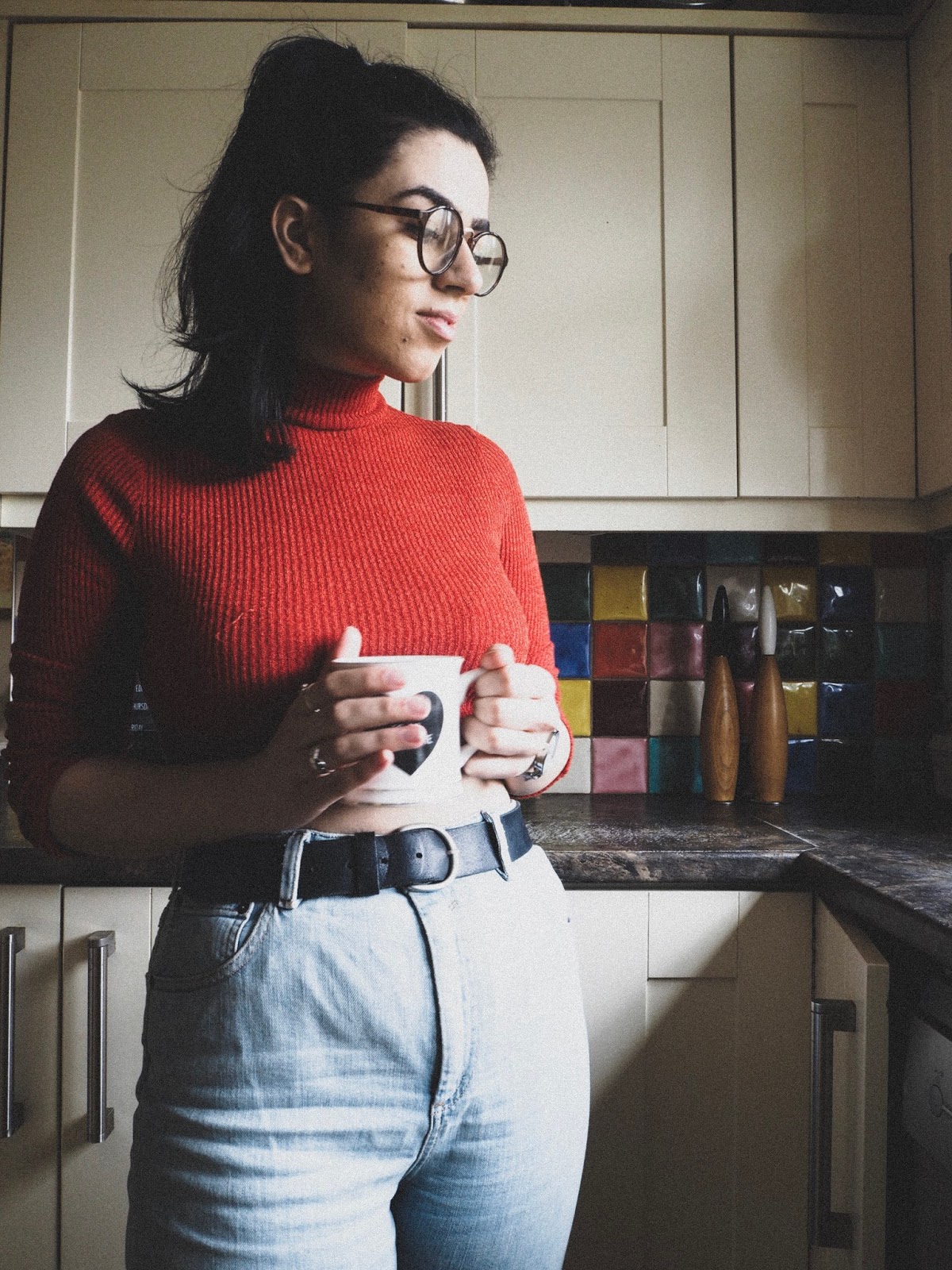 woman holding mug in kitchen
