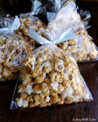 When you sweet tooth hits, but you also need something crunchy and a little salty, caramel corn is the perfect answer. This recipe makes nice crisp but buttery and sweet caramel corn. It comes together quickly and then bakes to the perfect finish. It is a must make for movie night, parties and game day! bags filled with crunchy caramel corn for party favors