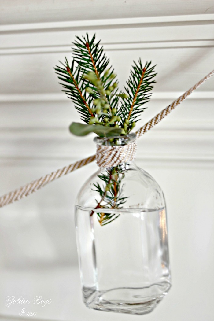 Small bottle garland with fresh greenery clippings as holiday decor - www.goldenboysandme.com