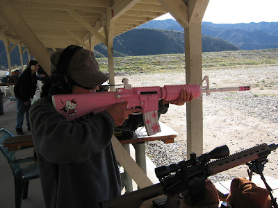 Hello Kitty shooting pink AR-15 rifle gun