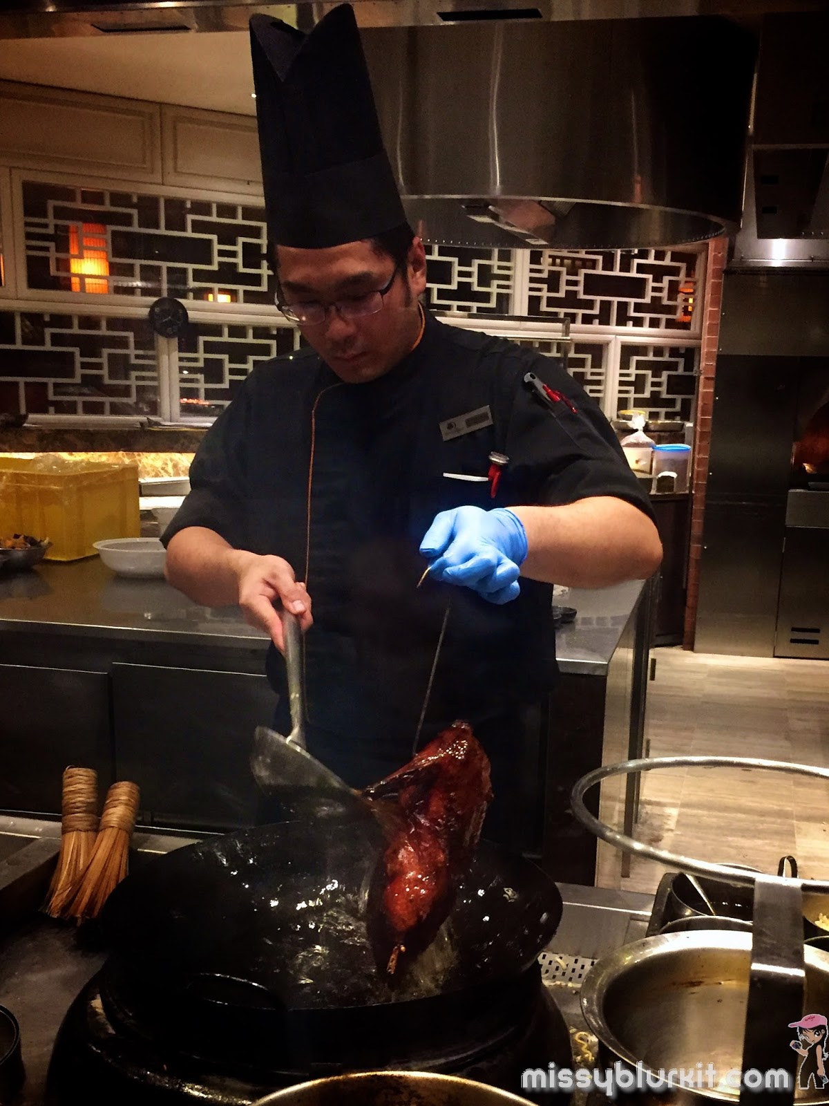 bathing the roasted duck with oil for a crispy skin effect Makan Kitchen, Double Tree