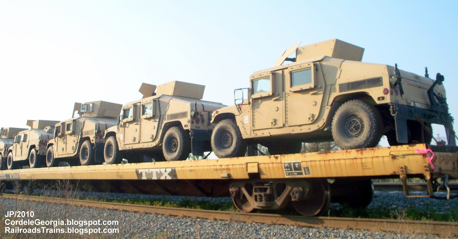Military US Army Vehicles on CSXT Railroad Freight Train passing thru 