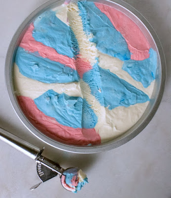 This red, white and blue no churn ice cream is super easy to make and so patriotic. Make a batch for Memorial Day, Independence Day and Veteran's Day. Then go ahead and make a batch for all of the days in between as well! scooping a helping of ice cream from pan