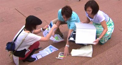 Misaki, Tsutsum and Wakamura pick up the brochures that fell out of Sekiyama's bag.