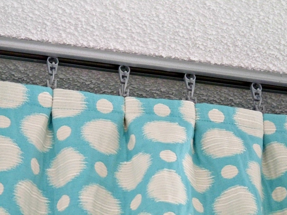 Gathered curtains on curtain track Gathered curtains on curtain track