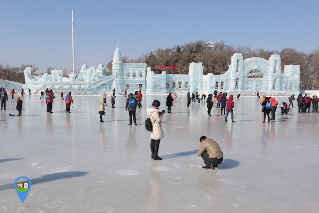 Visitors enjoy walking, playing with their top spins and cycling on the frozen lake at Harbin Snow Sculpture Art Expo in Heilongjiang province, China Visitors enjoy walking, playing with their top spins and cycling on the frozen lake at Harbin Snow Sculpture Art Expo in Heilongjiang province, China