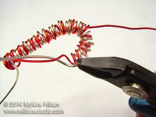 Trim away the excess silver wire at the hook end of the candy cane.