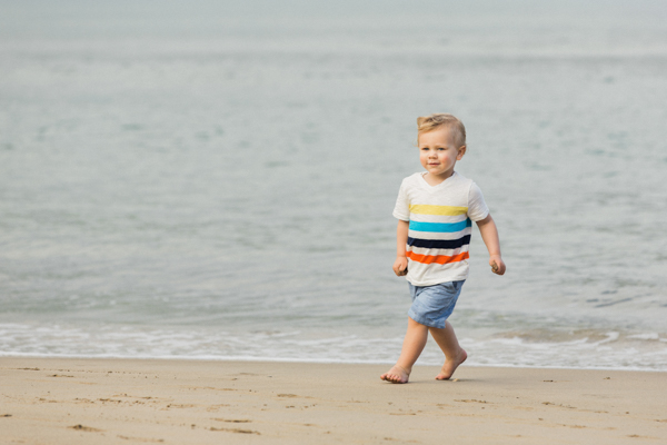 Toddler running on the sand in Hanalei Bay, Kauai