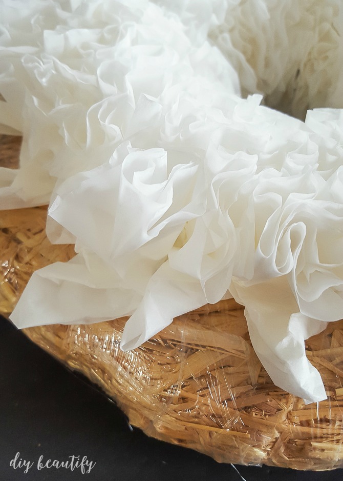 coffee filters are glued tightly together on straw wreath base