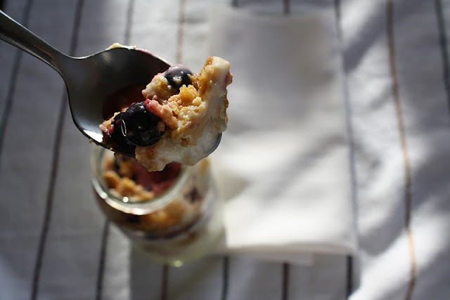 Close up of a spoonful of Graham Cracker Triple Berry Yogurt Parfait