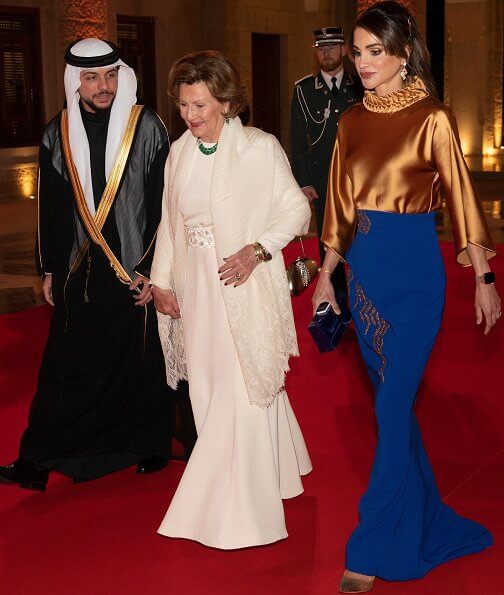 Satin blouse. Queen Sonja wore gold diamonds and emerald necklace. Queen Sonja wore gold and diamond leaf earrings.