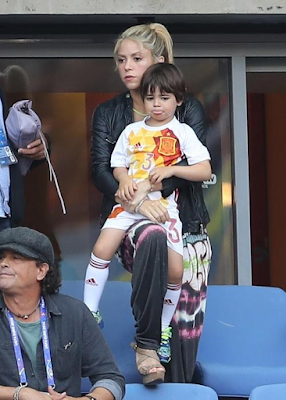 1a7 Shakira and sons cheers on her husband football star Gerard Pique during his game.