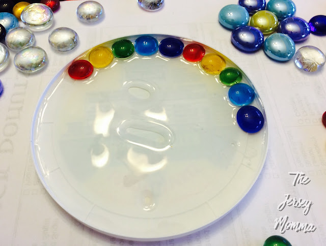 Sun Catcher Fill the yogurt lid with the clear Elmer's glue, before placing  the gems inside and pouring a bit …