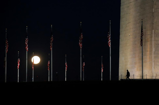Một người đàn ông đang bước đi qua khu vực công viên National Mall ở thủ đô Washington, Hoa Kỳ bên dưới ánh sáng của Mặt Trăng. Hình ảnh: Carlos Barria/Reuters. Một người đàn ông đang bước đi qua khu vực công viên National Mall ở thủ đô Washington, Hoa Kỳ bên dưới ánh sáng của Mặt Trăng. Hình ảnh: Carlos Barria/Reuters.