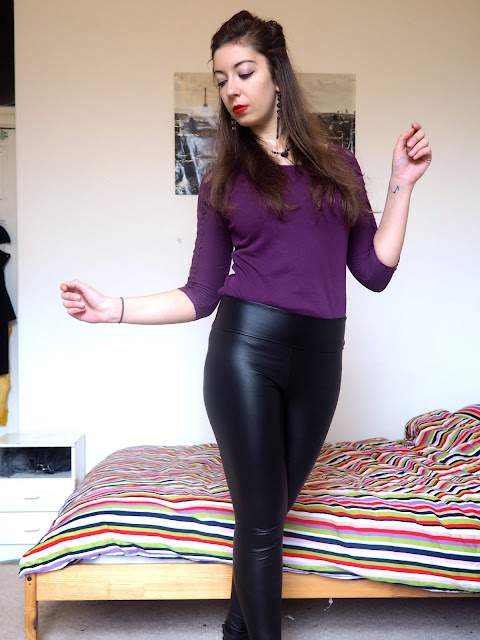 Ursula Disneybound outfit of purple lace sleeve top, black leather effect leggings, and black ankle boots
