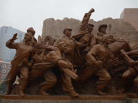 figures surrounding the Mao Zedong statue in Shenyang, China