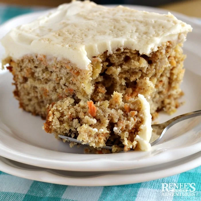 A forkful of Healthy Carrot Cake by Renee's Kitchen Adventures from a piece of cake on a white plate