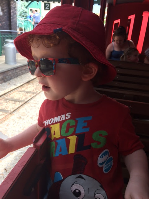 Little boy sitting in a train carriage