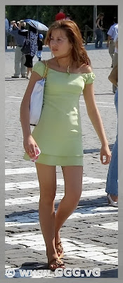 Girl in summer open back dress on the street 