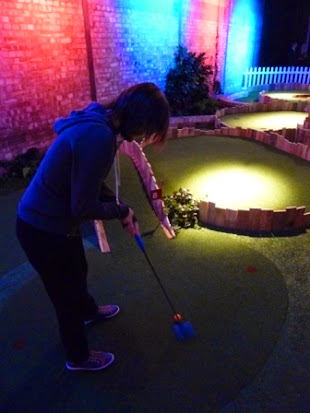 Emily on the tee at hole 8 at Swingers Crazy Golf course in London Swingers Crazy Golf in Shoreditch, London