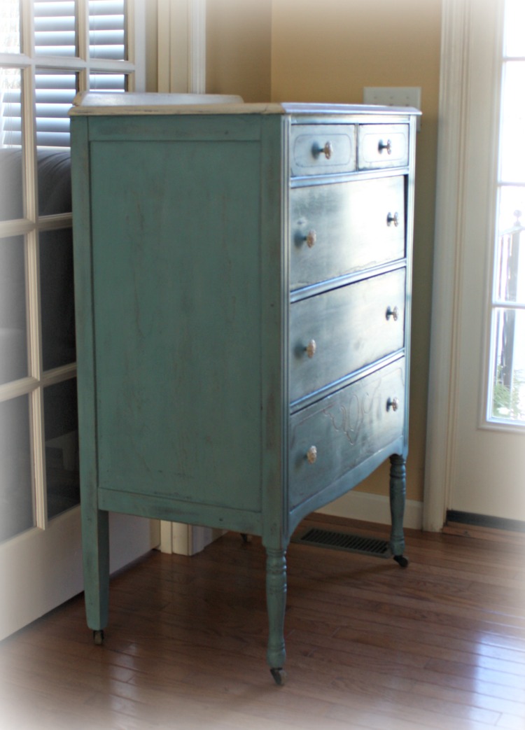 The dresser sits on the original wood wheels. The dresser sits on the original wood wheels.