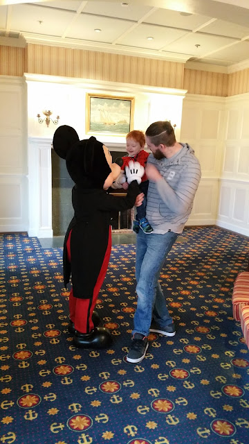 Dad, toddler and meeting Mickey